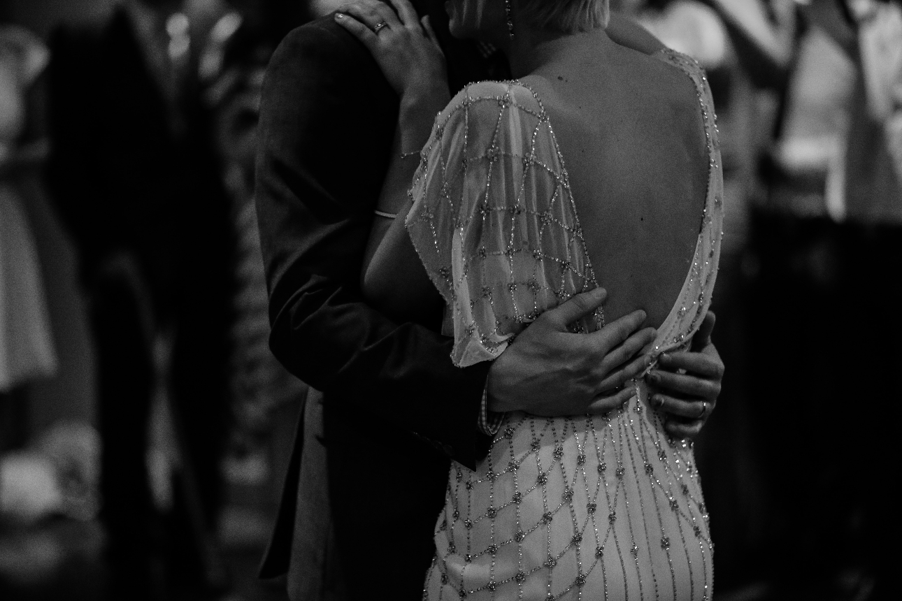 black and white image of a bride and groom dancing