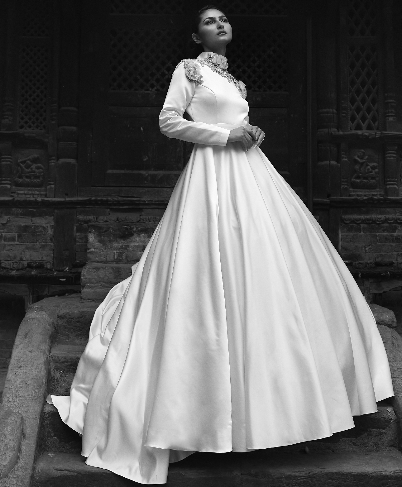 Model in dress. high neck and sleeves, black and white image